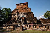Thailand, Old Sukhothai - Wat Mahathat, square-based, multi-layered chedi with statues of seated Buddha at each side, stucco figures of lions and elephants decorate the base.